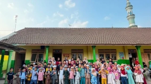 Gambar 1. Foto bersama mahasiswa KKN-Berdampak 119 UMM, pengajar TPQ, dan seluruh santri di halaman TPQ Desa Gampingan
